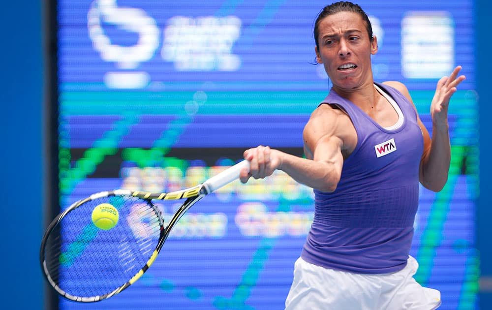Francesca Schiavone from Italy returns a shot against Samantha Stosur from Australia during their first round match at the China Open tennis tournament.