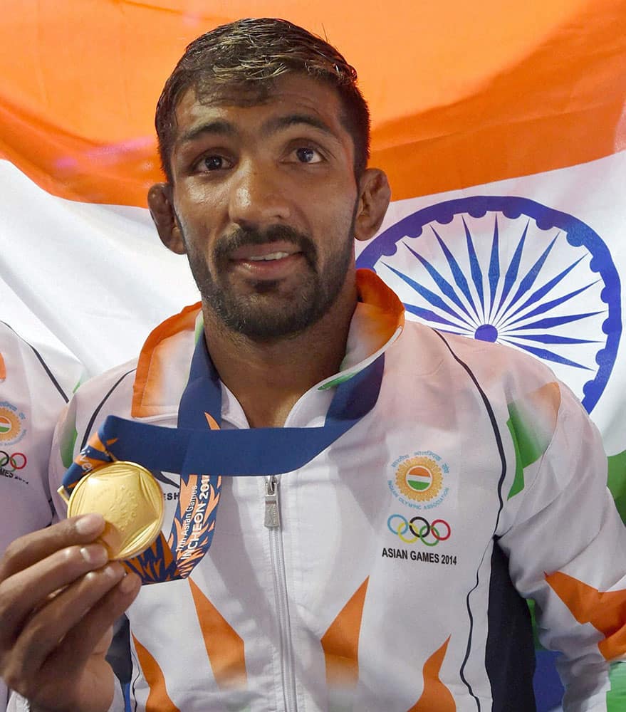 India`s Yogeshwar Dutt poses with gold medal after winning the mens 65 kg freestyle wrestling match at Dowon Gymnasium Stadium at Asian Games.