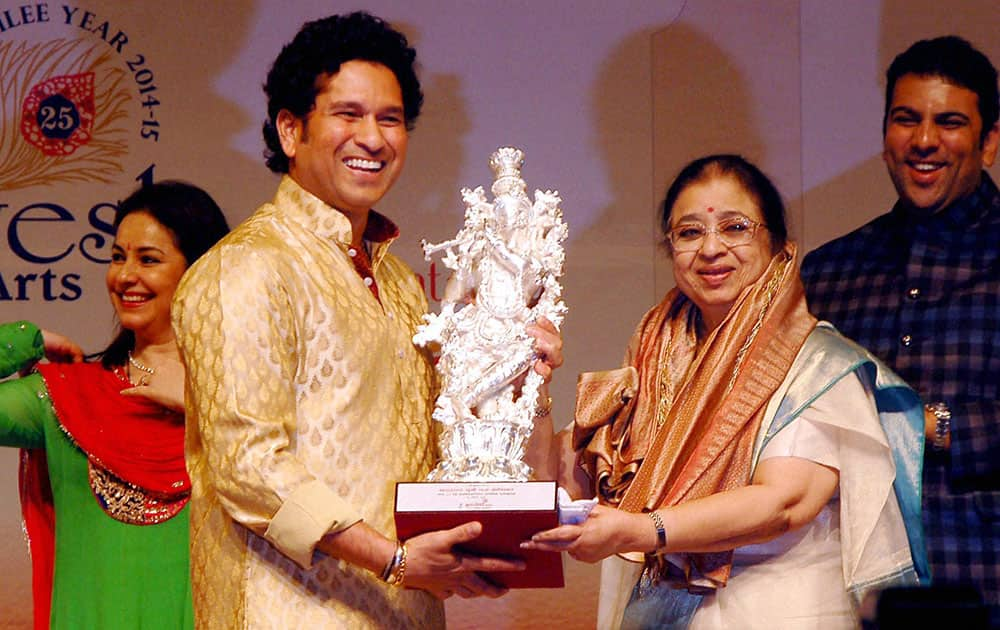 Cricketer Sachin Tendulkar presents a statue to Usha Mangeshkar for legendary singer Lata Mangeshkar on her 85th birthday in Mumbai.