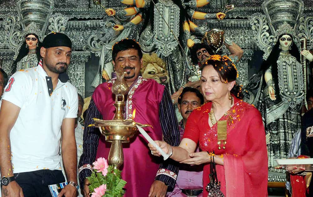 Actress Sharmila Tagore (R) and cricketer Harbhajan Singh on the occasion of Maha Panchami at Sreebhumi Sporting pandal, in Kolkata.