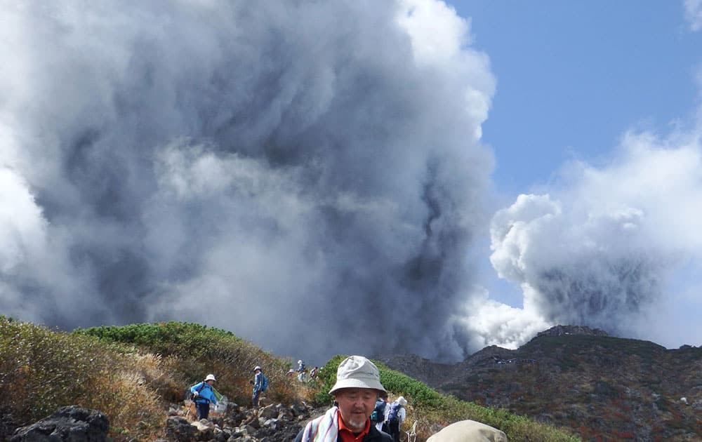 In this photo taken by an anonymous climber and was offered to Kyodo News, climbers descend Mt. Ontake to flee as the volcanic moutain erupts in central Japan.