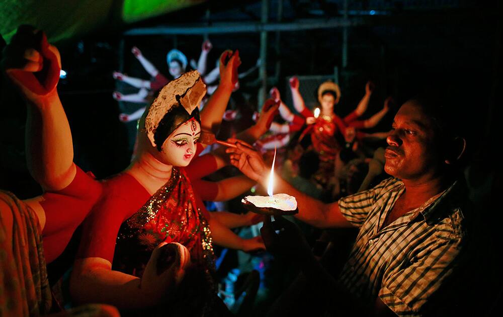 An artisan paints an idol of Hindu goddess Durga at a workshop in Guwahati.