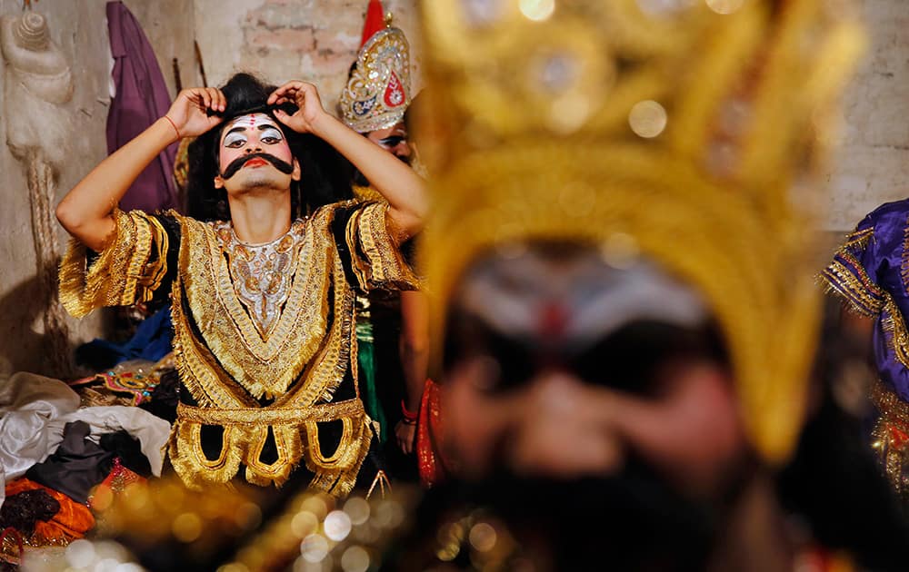 Artists prepare themselves before going on stage for a traditional Ramleela drama, narrating the life of Hindu God Rama, to celebrate the festival of Dussehra in Allahabad.