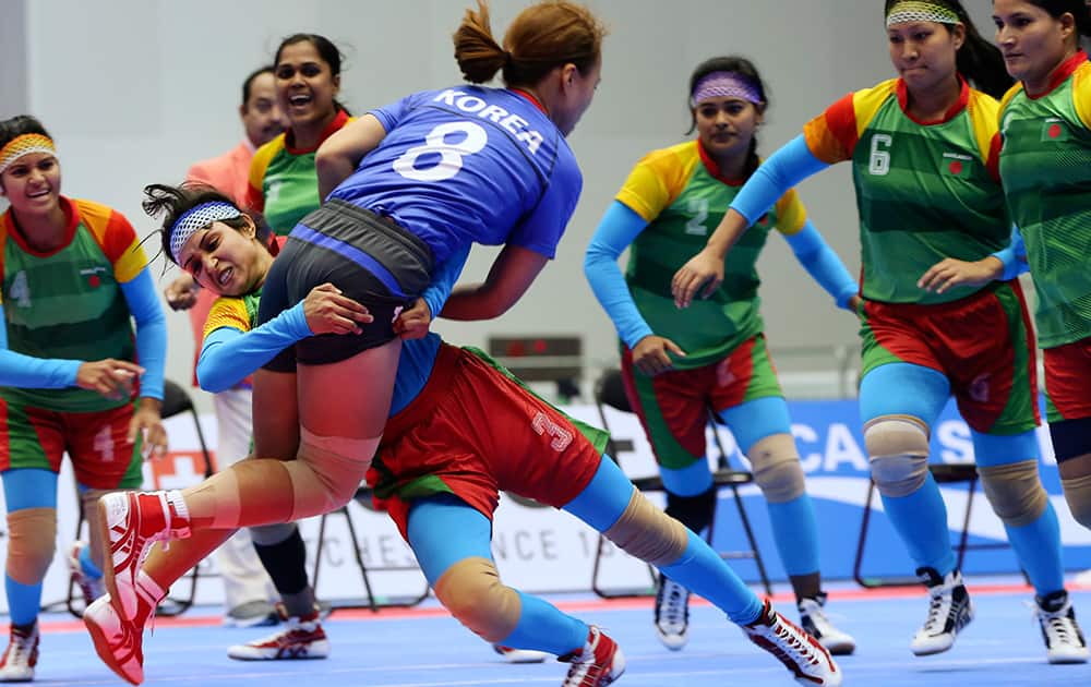 Bangladesh's Sharmin Sultana Rima takes down South Korea's Shin So-min (8) during the women's team kabbadi preliminary match at the 17th Asian Games in Incheon, Korea.