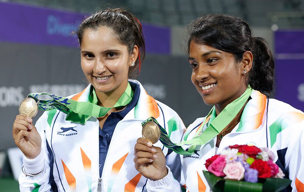 Bronze medal winners Prarthana Gulabrao Thombare and Sania Mirza celebrate after winning the women's doubles tennis match at the 17th Asian Games in Incheon, South Korea.