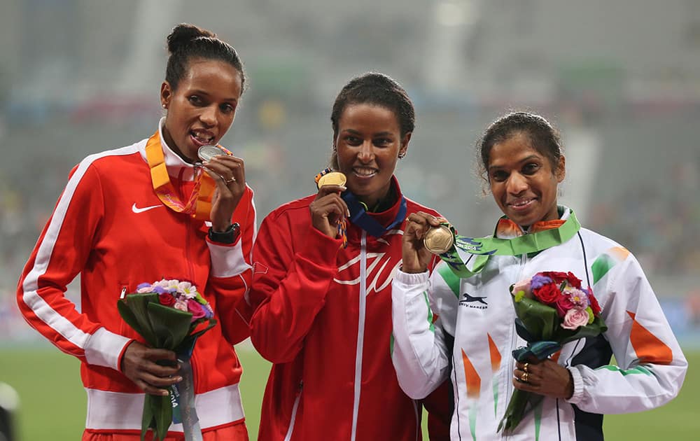Gold winner Bahrain's Maryam Ysuf Isa Jamal, center with silver winner Bahrain's Mimi Belete, left and bronze winner India's Jaisha Orchatteri Puthiya Veetil pose during the medal ceremony of the women's 1500m event at the 17th Asian Games in Incheon, South Korea.