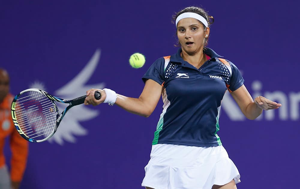 Sania Mirza returns a shot during the mixed doubles gold medal tennis match against Taiwan's Peng Hsien Yin and Chan Hao Ching at the 17th Asian Games in Incheon, South Korea.