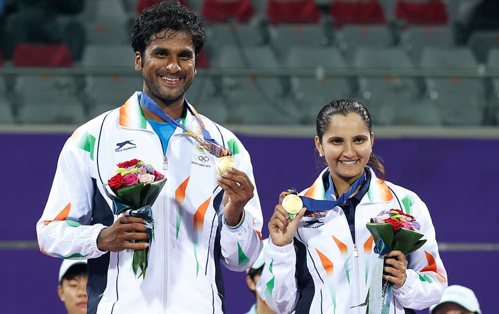 Gold medal winners Sania Mirza and Saketh Sai Myneni celebrate after winning the mixed doubles tennis match at the 17th Asian Games in Incheon, South Korea.