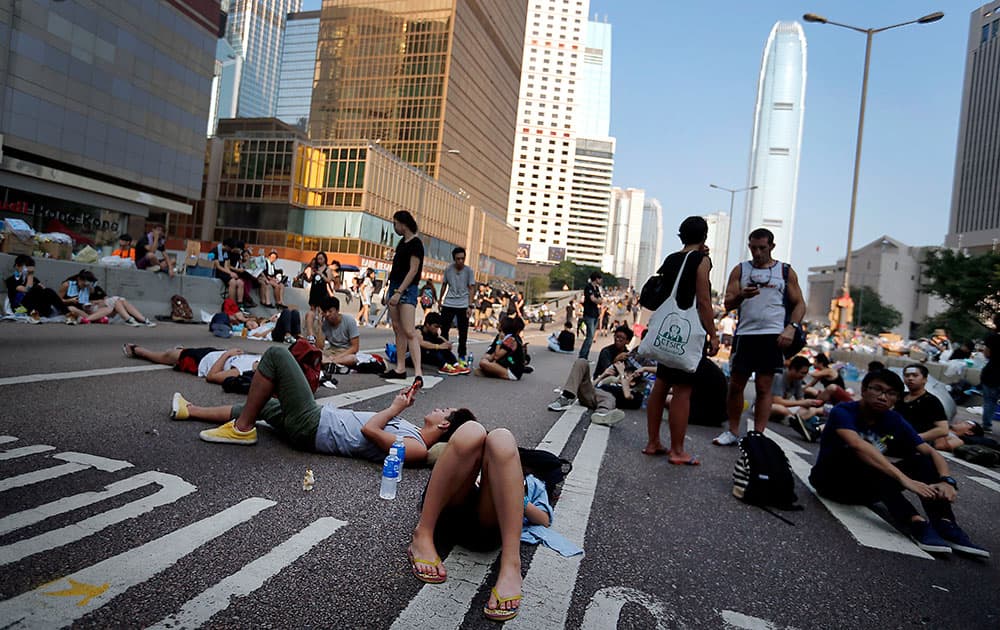 Student activists sleep on a road leading to the financial district, where pro-democracy activists have gathered and made camp, in Hong Kong.