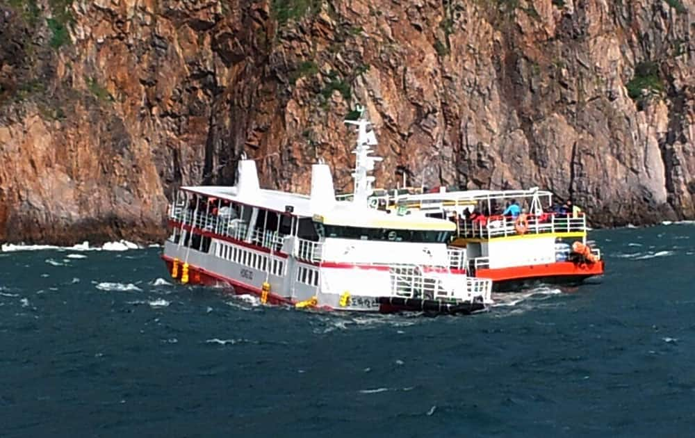 A cruise ship, right, approaches to rescue passengers from an another cruise ship that ran aground in waters off the southwestern coast near Hongdo, South Korea.