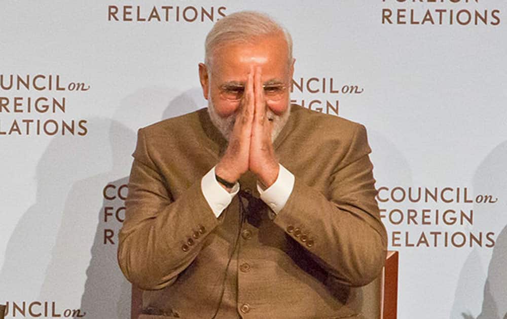 India's Prime Minister Narendra Modi, right, clasps his hands and bows as he ends his visit to the Council on Foreign Relations.