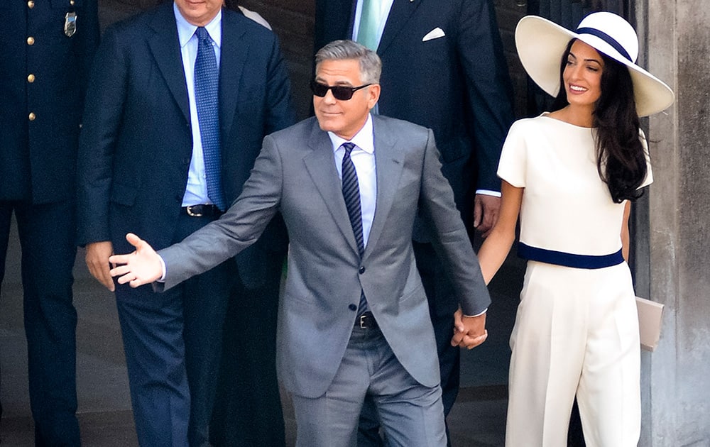 Actor George Clooney and Amal Alamuddin leave after a civil weeding ceremony at the town hall in Venice, Italy.