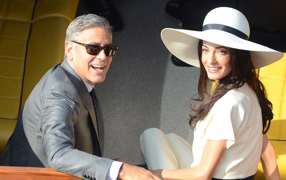 George Clooney and his wife Amal Alamuddin leave the city hall after their civil marriage ceremony in Venice, Italy.