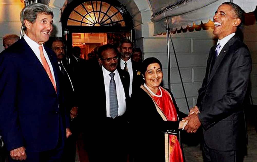 US President Barack Obama greets External Affairs Minister Sushama Swaraj at the White House in Washington. US Secretary of State John Kerry(L) is also seen. 