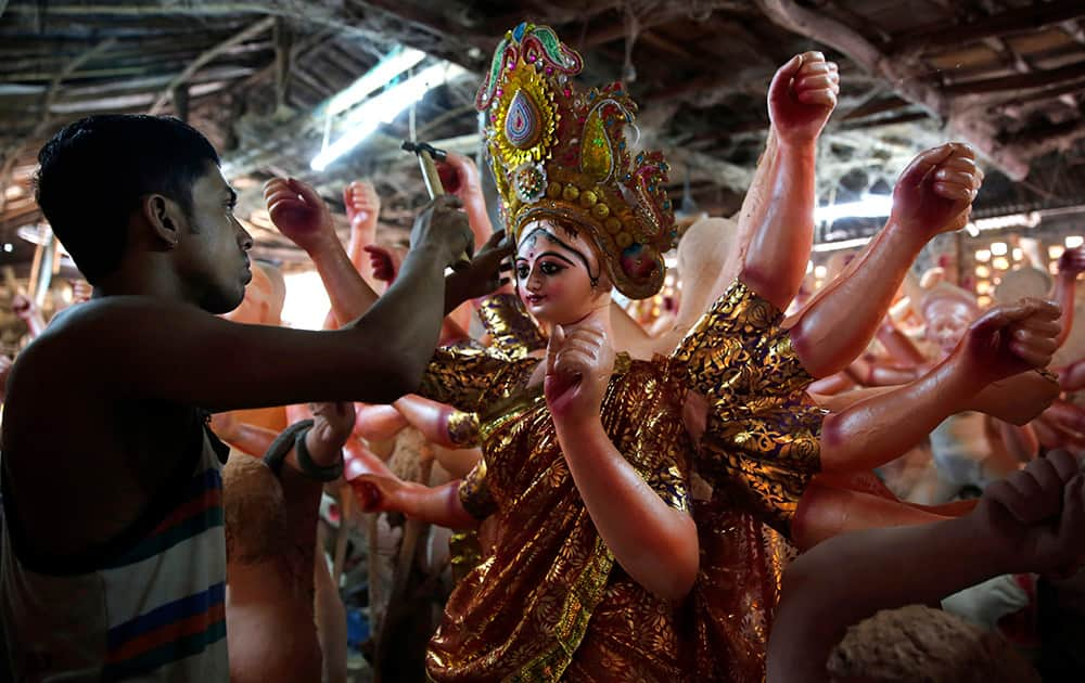 A artist works on an idol of Hindu goddess Durga, at a workshop in Allahabad.