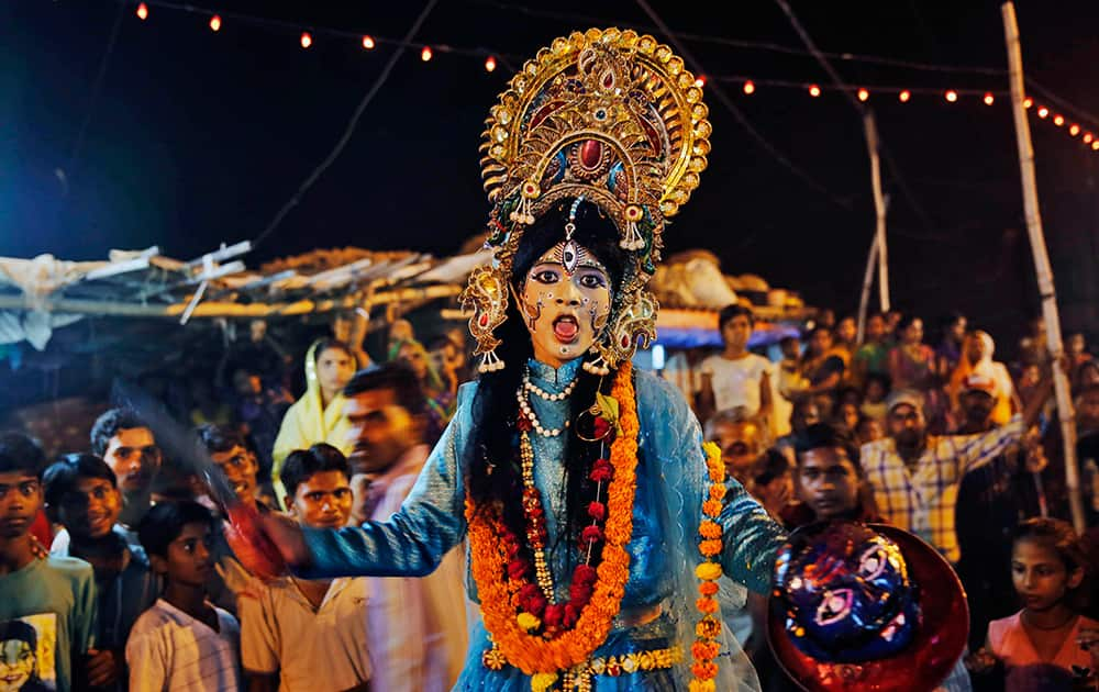 A girl dressed as Hindu goddess of destruction, Kali, acts in a street play ahead of Dussehra festival in Allahabad.