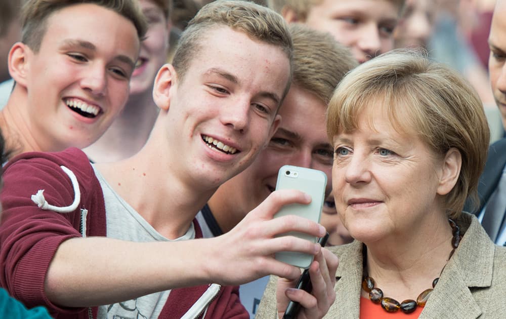 Students make a selfie with German Chancellor Angela Merkel during her visit to the Praelat-Diehl-school in Gross Gerau, Germany.