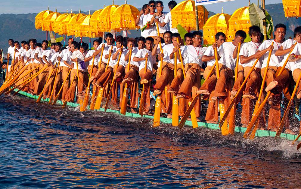 Ethnic Inntha people row a long boat by legs as they celebrate the annual Paung-Daw -Oo pagoda festival in Inlay Lake, Southern Shan State, Myanmar.