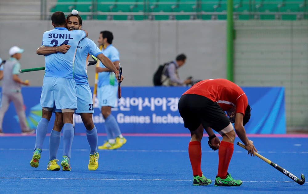 Indias Sunil Vitalacharya Sowmarpet and Akashdeep Singh celebrate their victory over South Korea during their Mens Hockey semifinal match at the Asian Games in Incheon.