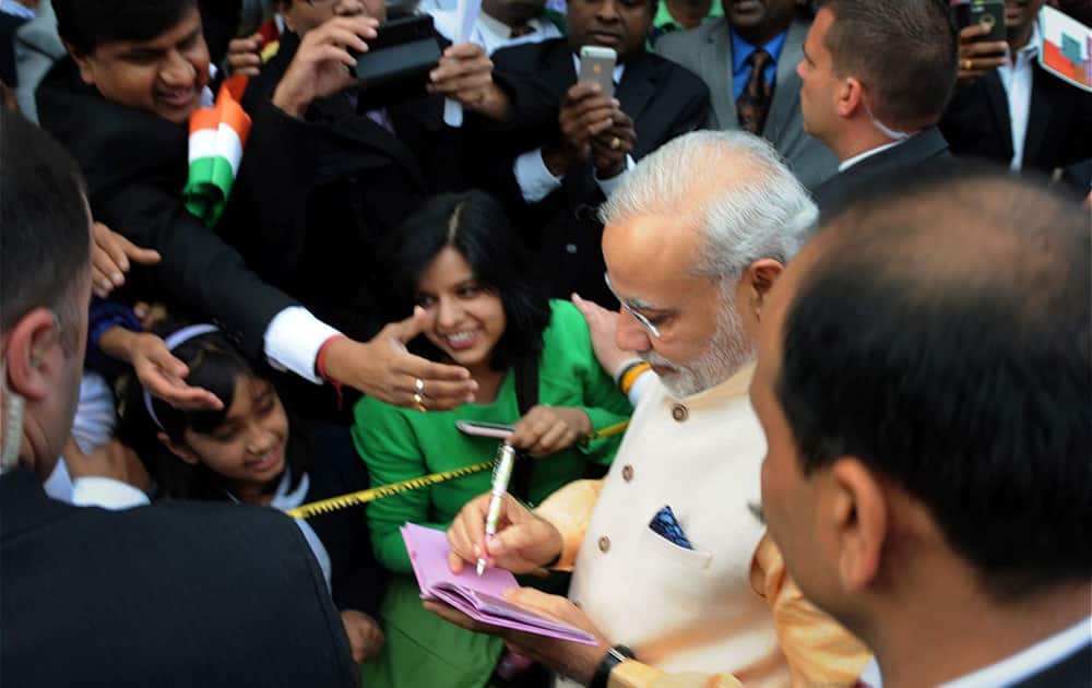 Prime Minister Narendra Modi signing autographs children of Indian community in Washington DC.