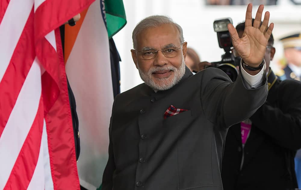 Indian Prime Minister Narendra Modi waves as he arrives at the White House, for a meeting with President Barack Obama in the Oval Office.