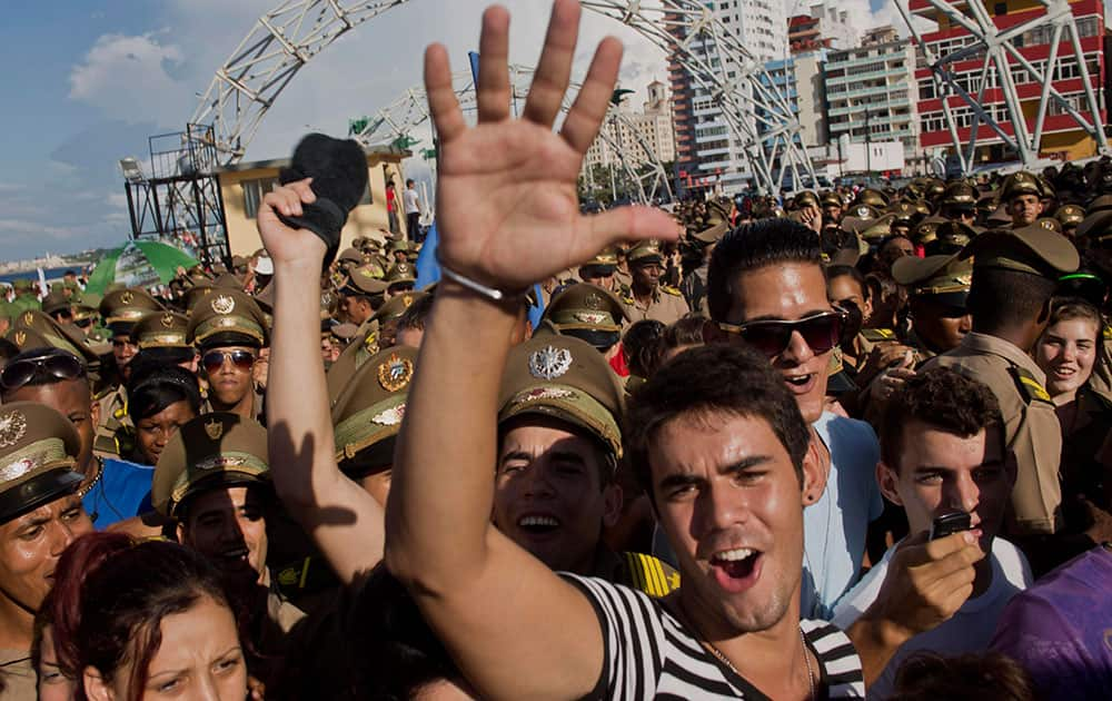 Young students enjoy a show by Cuban singer David Blanco at the end of a march against terrorism in Havana, Cuba.