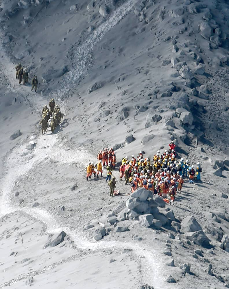 Rescuers conduct a search operation near the peak of Mount Ontake in central Japan.