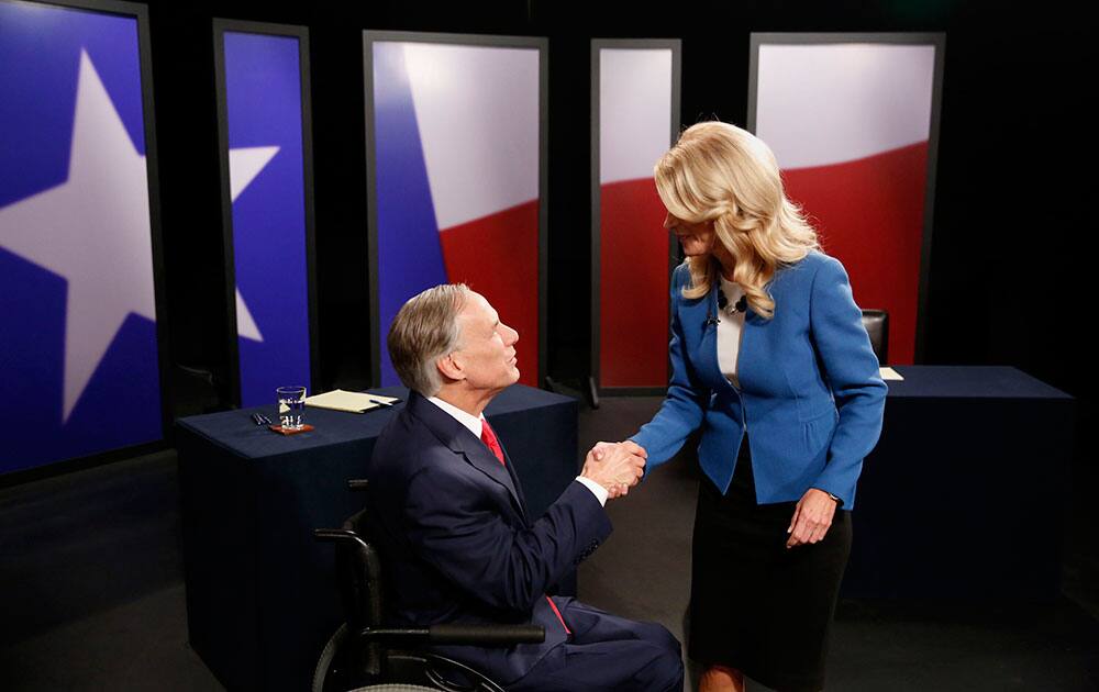 Texas State Senator Wendy Davis, right, Democratic Gubernatorial candidate, and Texas Attorney General Greg Abbott, left, Republican Gubernatorial candidate, shake hands before the final gubernatorial debate in a KERA-TV studio in Dallas.