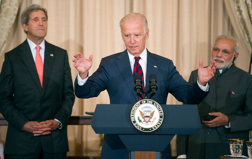 Indian Prime Minister Narendra Modi, right, and State John Kerry, left, listen as Vice President Joe Biden speaks during a luncheon at the State Department in Washington.