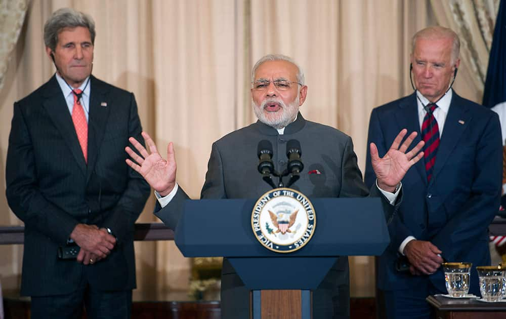 Indian Prime Minister Narendra Modi, center, flanked by Secretary of State John Kerry and Vice President Joe Biden, speaks during a luncheon in his honor, at the State Department in Washington. 