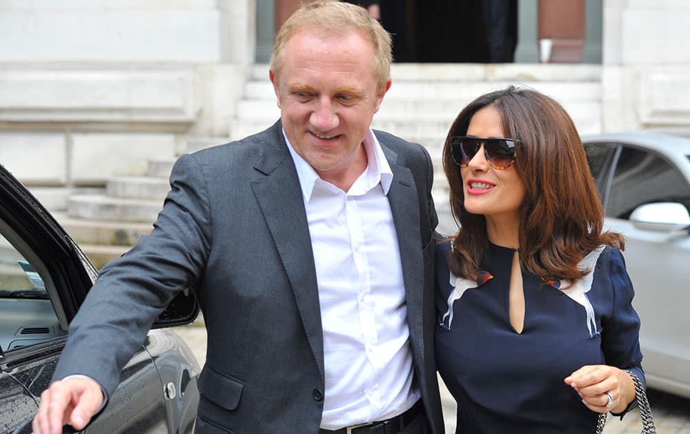 Mexican actress Salma Hayek and her husband Francois-Henri Pinault, CEO of luxury group Kering, leave after Stella McCartney's Spring/Summer 2015 ready-to-wear fashion collection presented in Paris