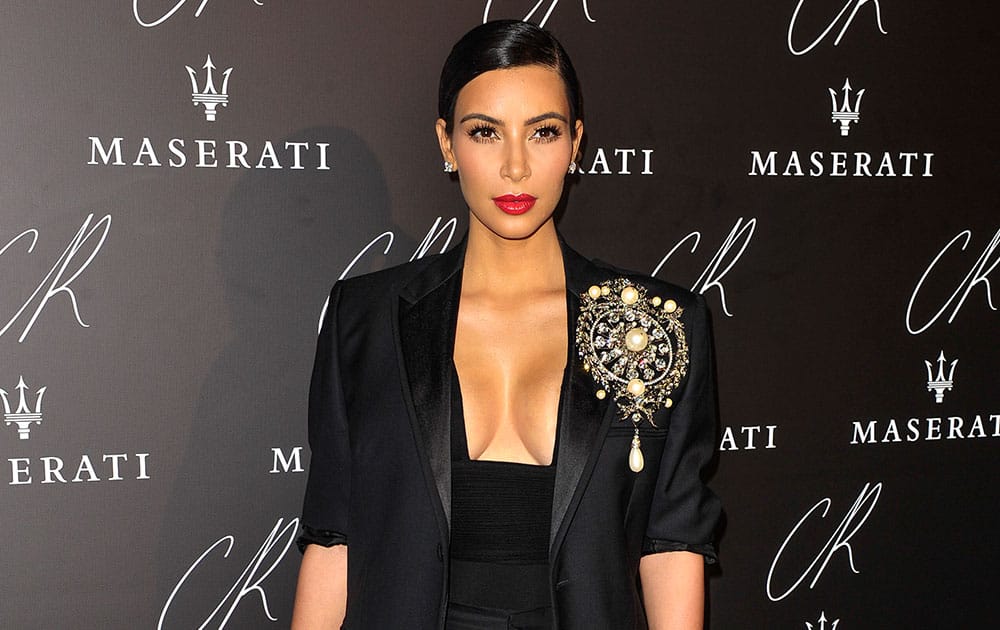 Kim Kardashian poses at Carine Roitfeld & Stephen Gan celebration of the launch of CR Fashion Book N.5 in Paris.