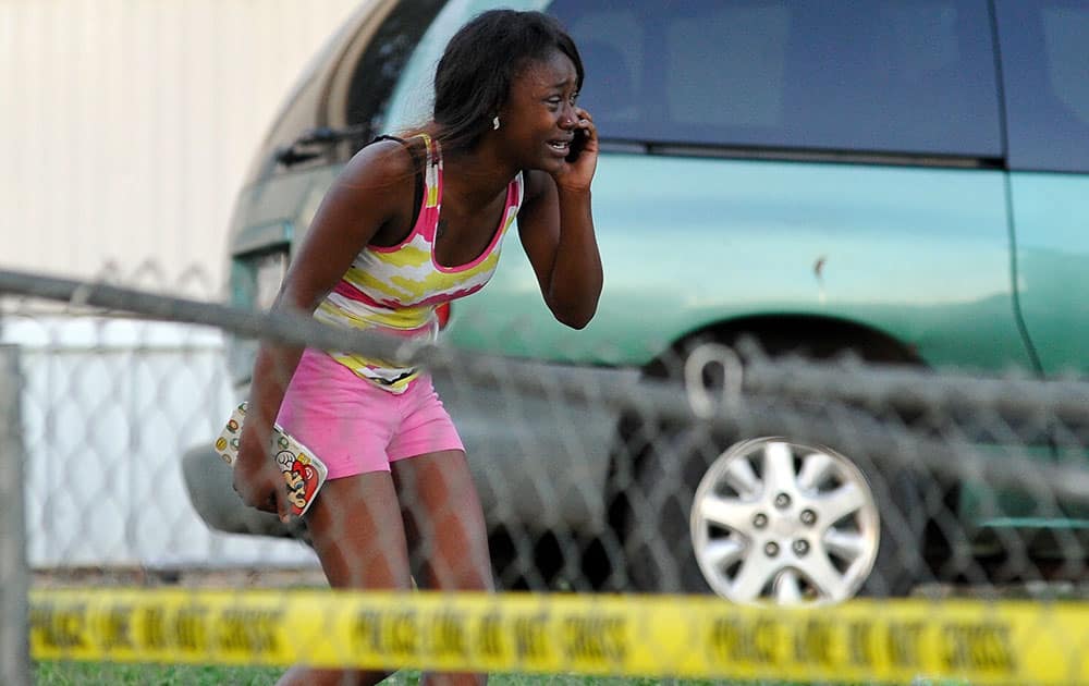 A woman reacts after receiving news that a loved one was killed during a shooting near a mobile home community on Athens east side behind the Airport Minit Market, in Athens, Ga. 