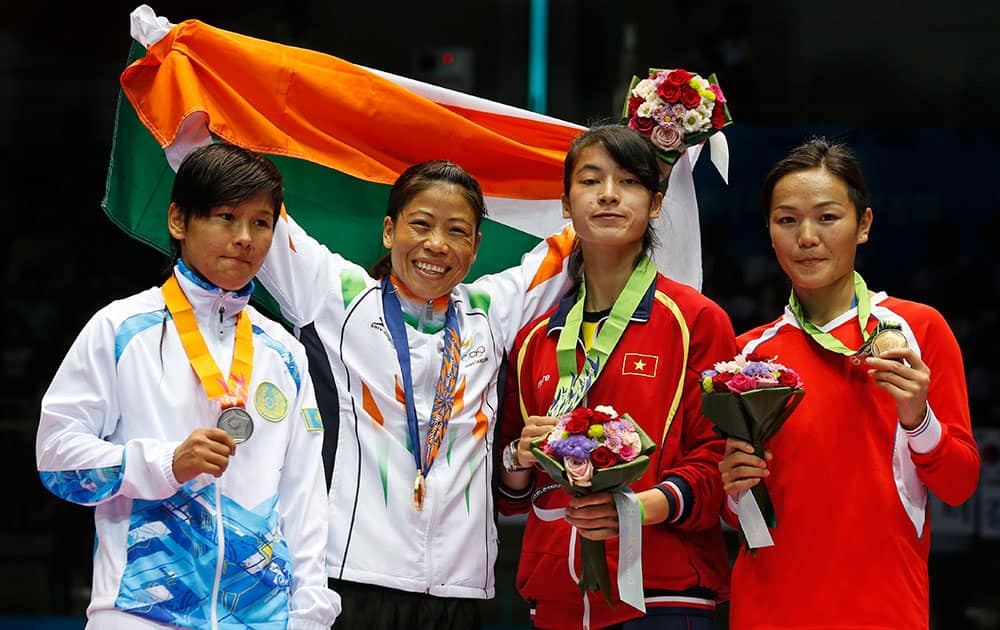 From left, silver medallist Kazakhstan’s Zhaina Shekerbekova, gold medallist India’s M.C. Mary Kom and bronze medallists Vietnam's Thi Bang Le and Mongolia's Nandintsetget Myagmardulam stand for the medal ceremony for the women’s flyweight (48-51kg) boxing at the 17th Asian Games in Incheon, South Korea.