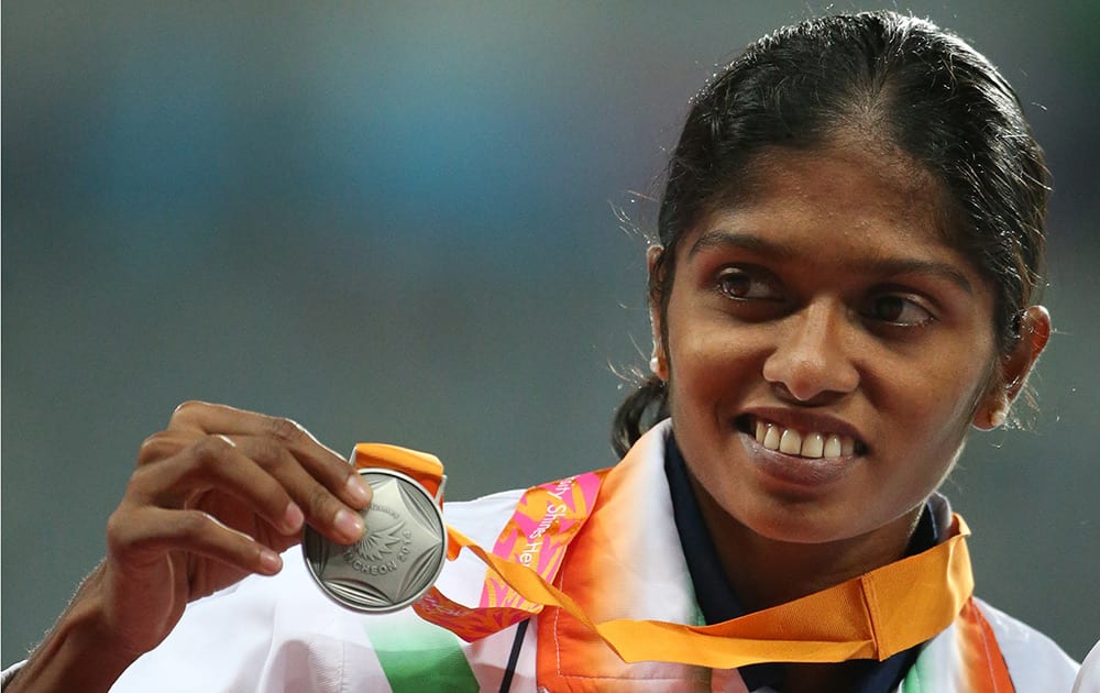 Silver winner India's Tintu Lukka, poses during the medal ceremony of the women's 800m final at the 17th Asian Games in Incheon, South Korea.