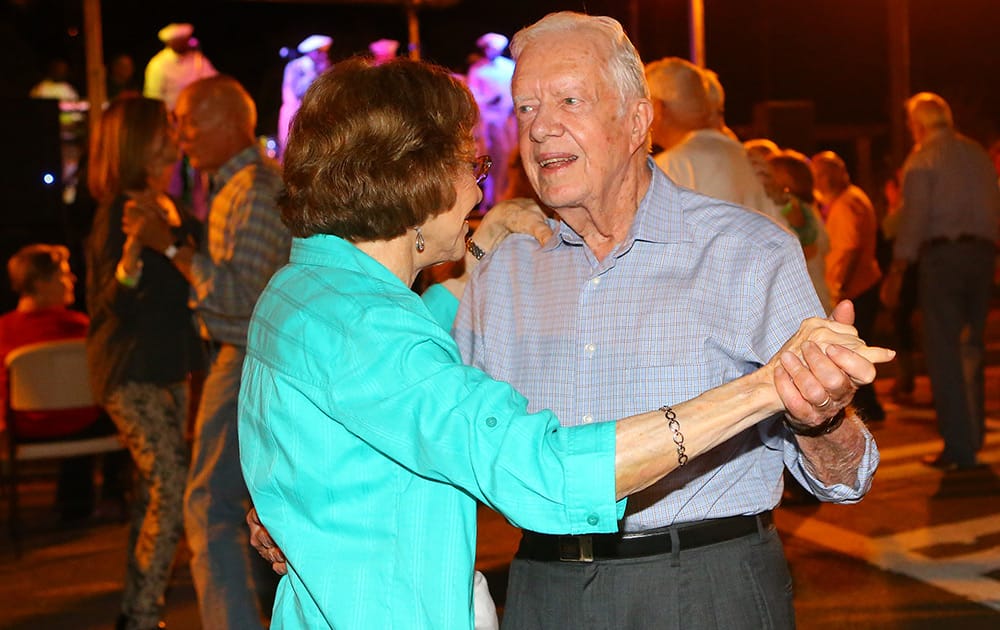 Former President Jimmy Carter and former first lady Rosalynn Carter dance on Main Street during the 18th Annual Plains Peanut Festival in Plains, Ga