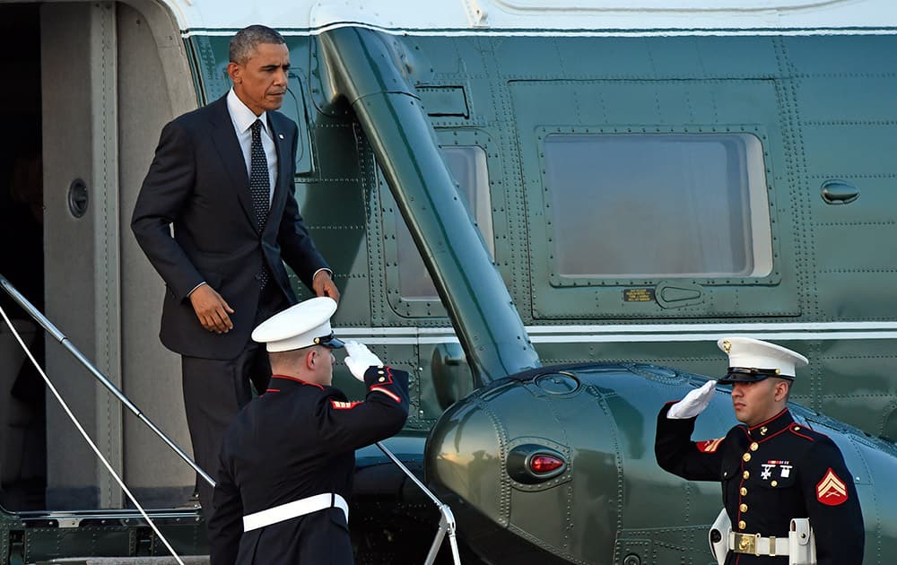 President Barack Obama walks off of Marine One at Andrews Air Force Base, Md.