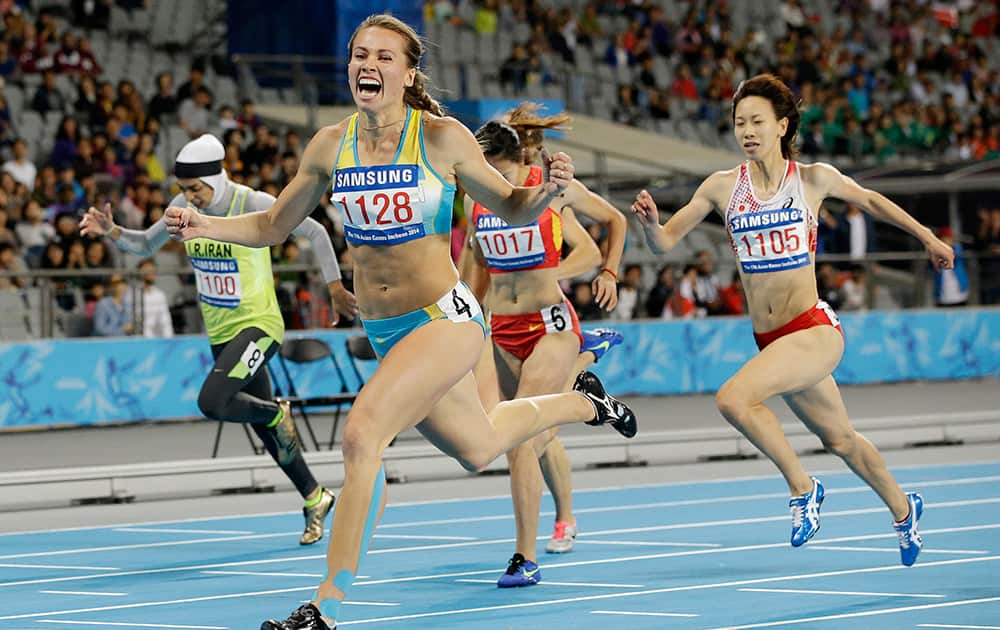 Kazkhstan's Olga Safronova reacts as she crosses the finish line to win the women's 200m final at the 17th Asian Games in Incheon, South Korea.
