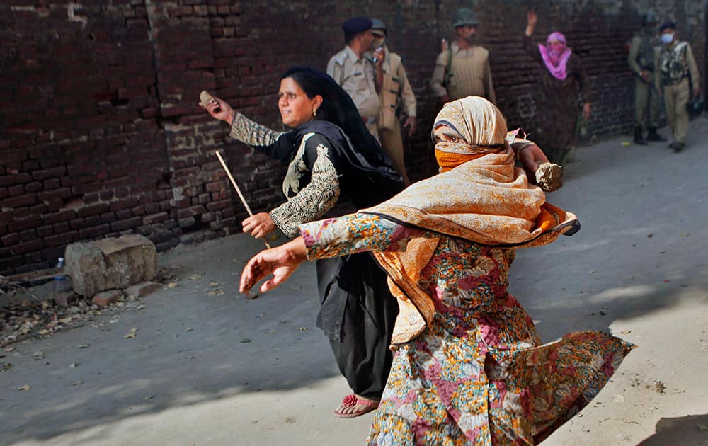 Muslim protesters hurl bricks and stones at policemen during a protest in Srinagar.