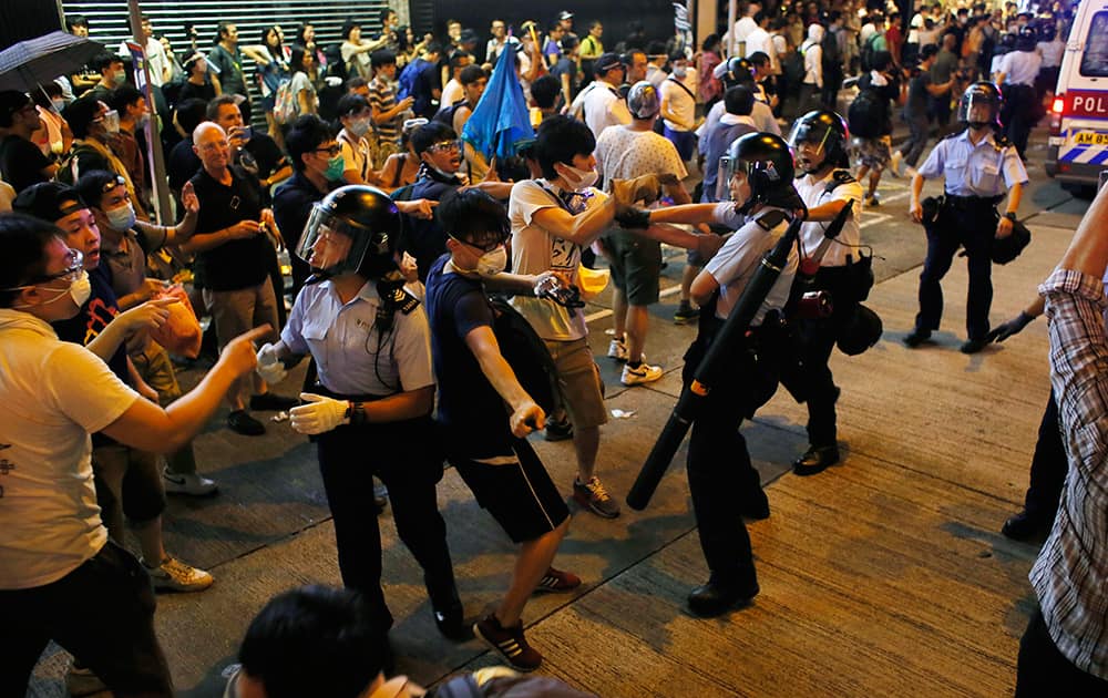 Student protesters mixed with expatriates scuffle with police in an entertainment area in Hong Kong.
