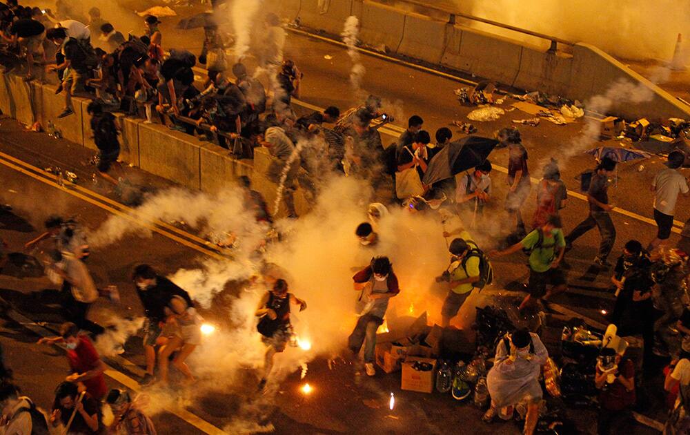Riot police use tear gas against protesters after thousands of people blocked a main road at the financial central district in Hong Kong