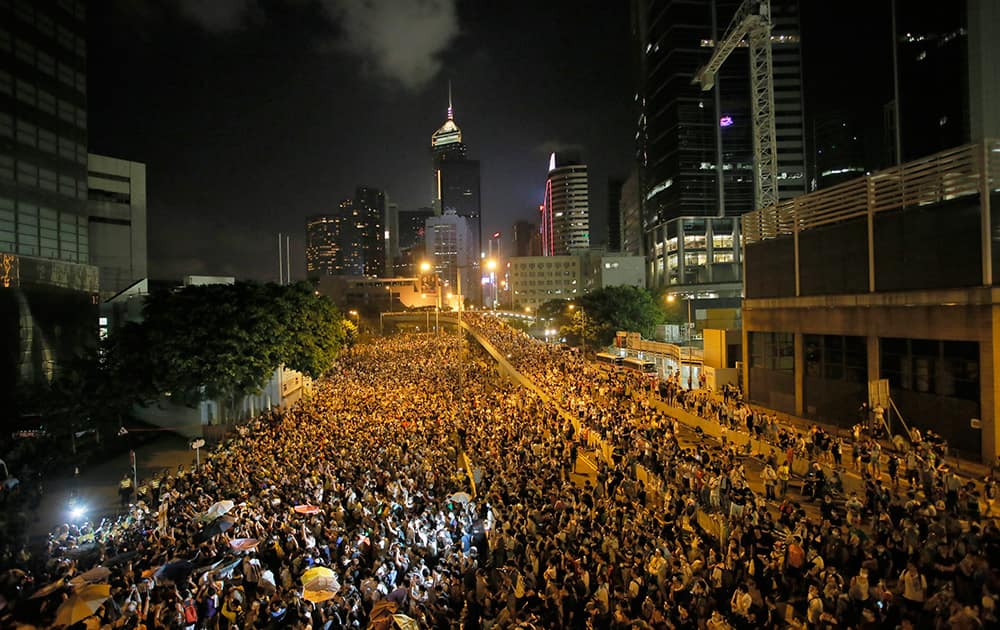 Protesters gather at a main road at the financial central district after riot police use tear gas against them after thousands of people blocked the road in Hong Kong.