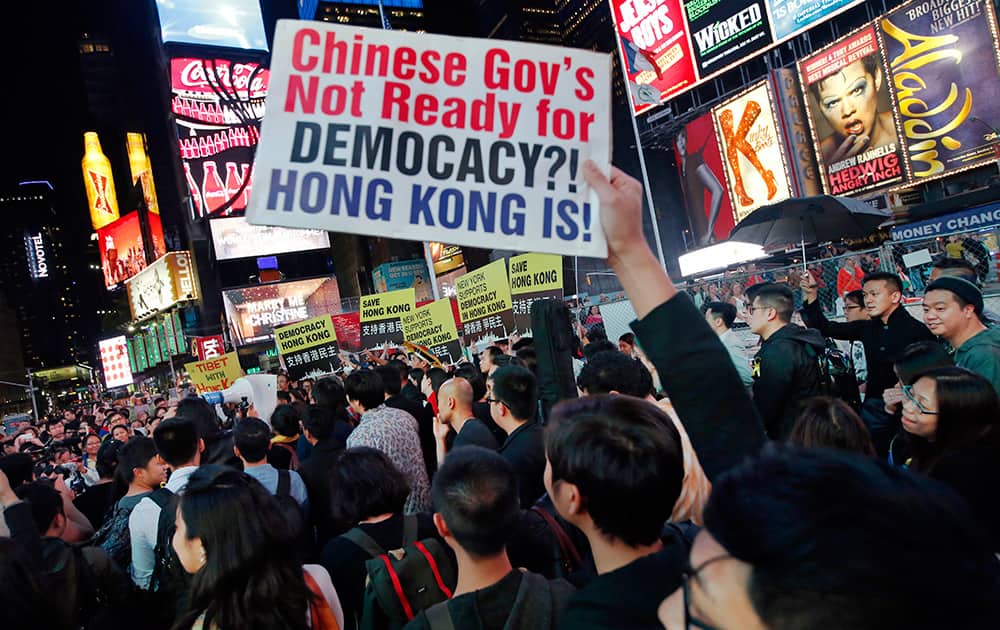 Protesters show their solidarity with Hong Kong protesters during a rally, in Times Square in New York.