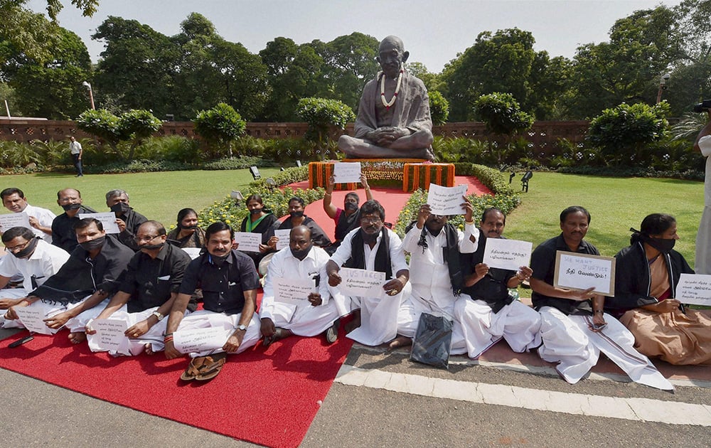 AIADMK MPs observe a fast in front of Mahatma Gandhis statue in Parliament House, demanding justice for party supremo and former Tamil Nadu Chief Minister J Jayalalithaa in New Delhi.