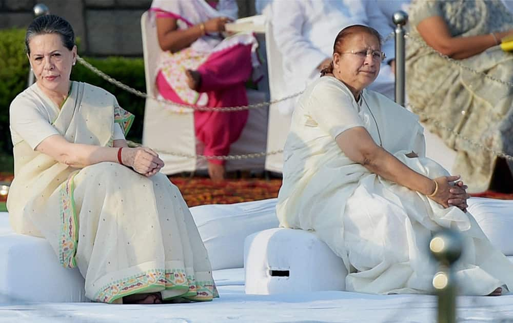 Congress President Sonia Gandhi and Lok Sabha Speaker Sumitra Mahajan at Rajghat on the occasion of Mahatma Gandhis 145th Birth Anniversary in New Delhi.