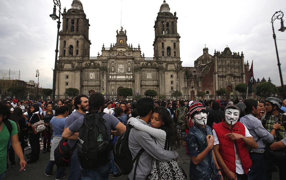 A young couple embraces during a march commemorating the anniversary of the Tlatelolco massacre, in the Zocalo, Mexico City's main square.