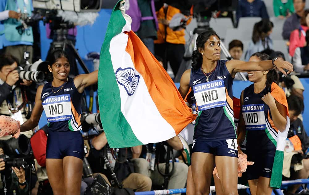 Members of India's women's 4 x 400 meters relay team celebrate after winning the gold medal at the 17th Asian Games in Incheon, South Korea.