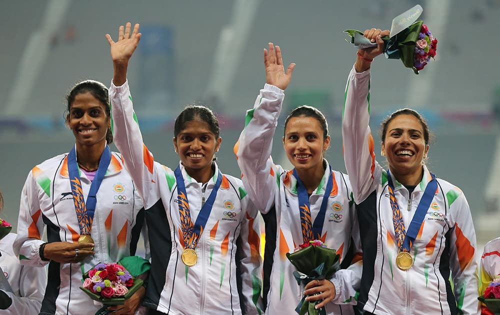 Indian team who won the gold wave during the medal ceremony of the women's 4 x 400m relay event at the 17th Asian Games in Incheon