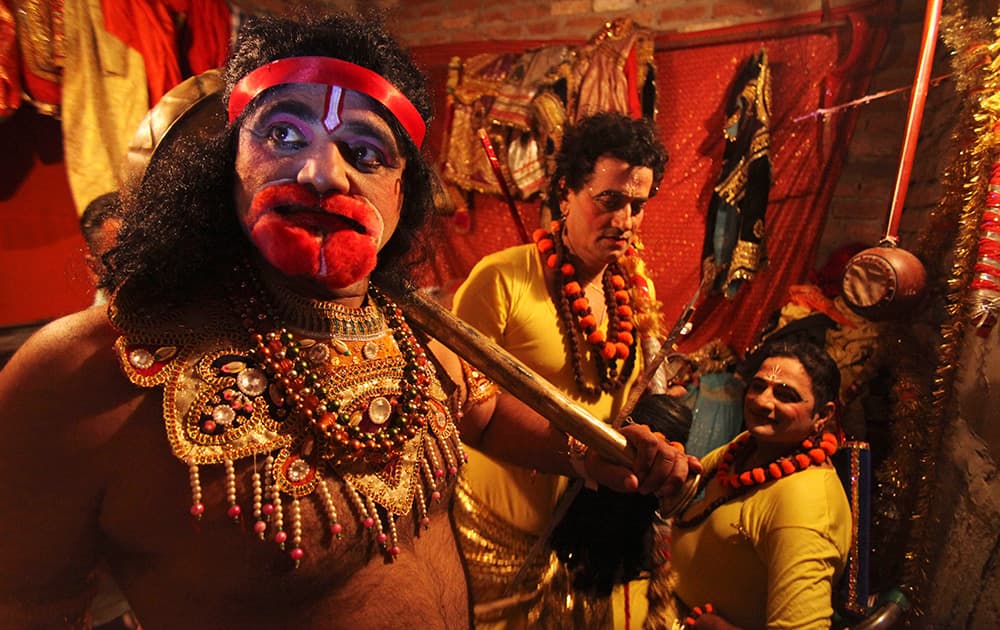 Artists get ready backstage for 'Ramleela', a theater performance depicting the Hindu epic Ramayana as part of Dussehra festival celebrations.