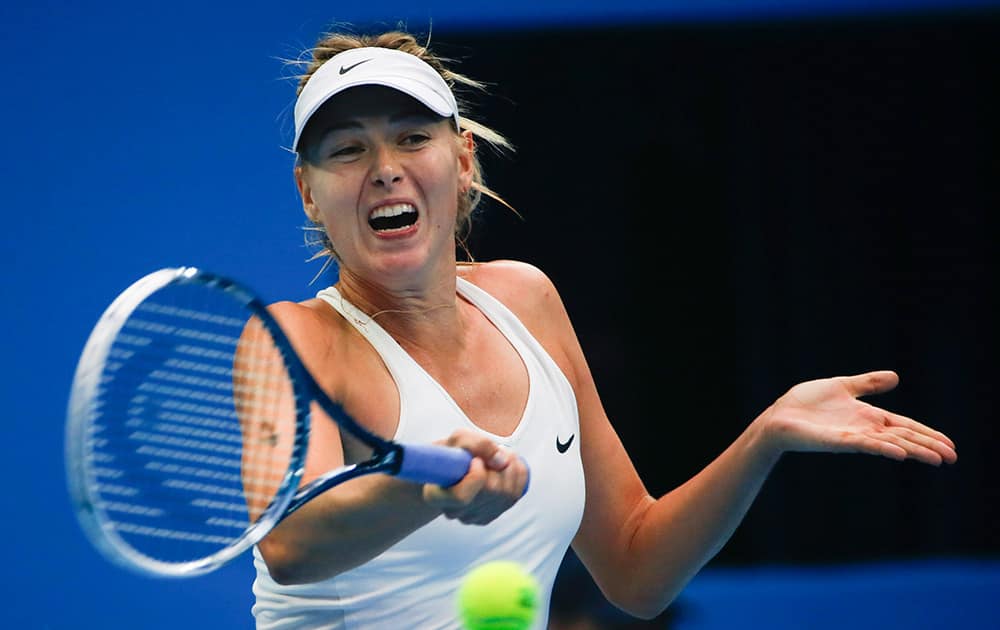 Maria Sharapova of Russia return a shots against Svetlana Kuznetsova of Russia during the China Open tennis tournament at the National Tennis Stadium in Beijing, China.